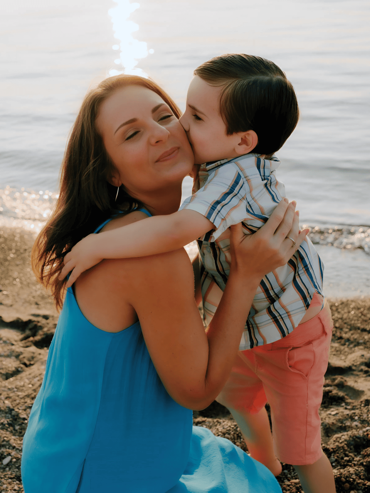 little boy kissing his mom on cheek